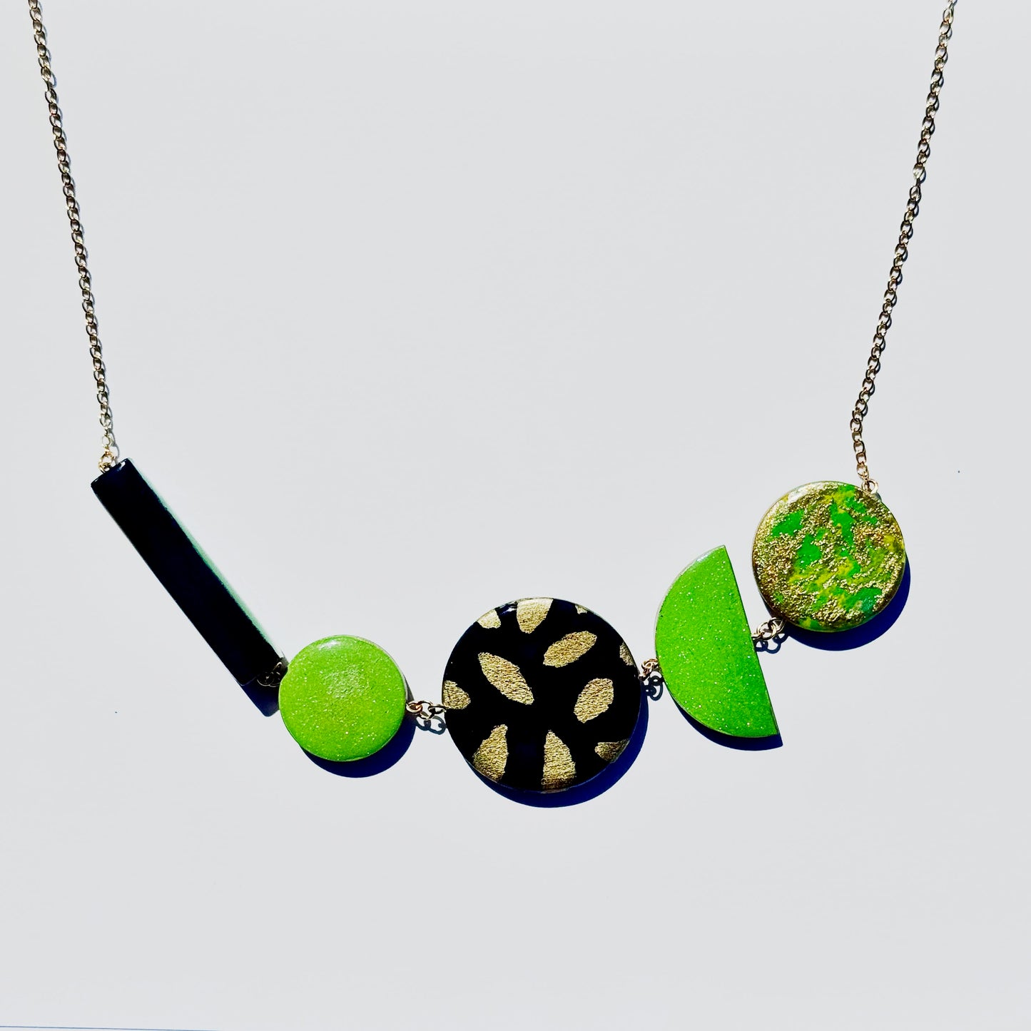 Twist ‘N’ Go Green Gold Hand-Painted Transforming Wooden Necklace – Multi-Shape Statement Piece
